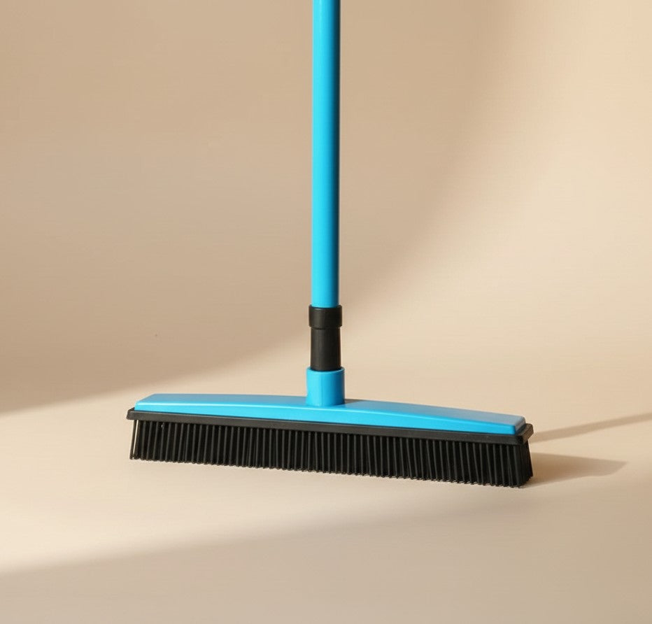 Nuzzle & Co blue pet hair removal broom with black silicone bristles for effective floor cleaning