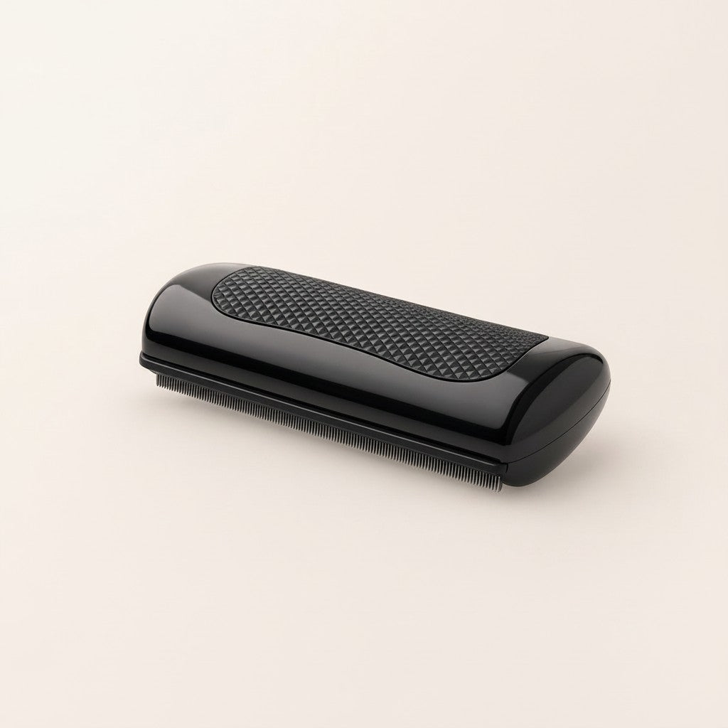 Nuzzle & Co dual-sided black pet deshedding comb with a textured non-slip grip for dogs and cats
