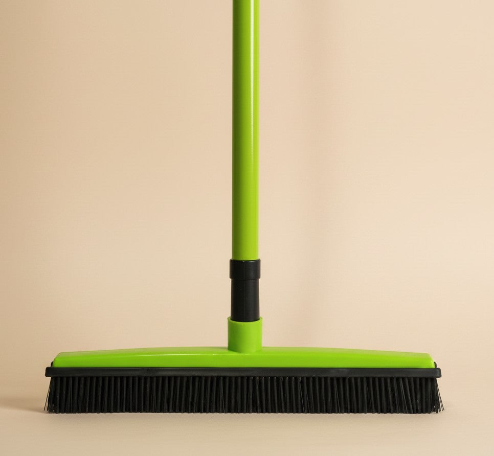 Nuzzle & Co lime green silicone pet hair removal broom with black bristles for multi-surface floor cleaning