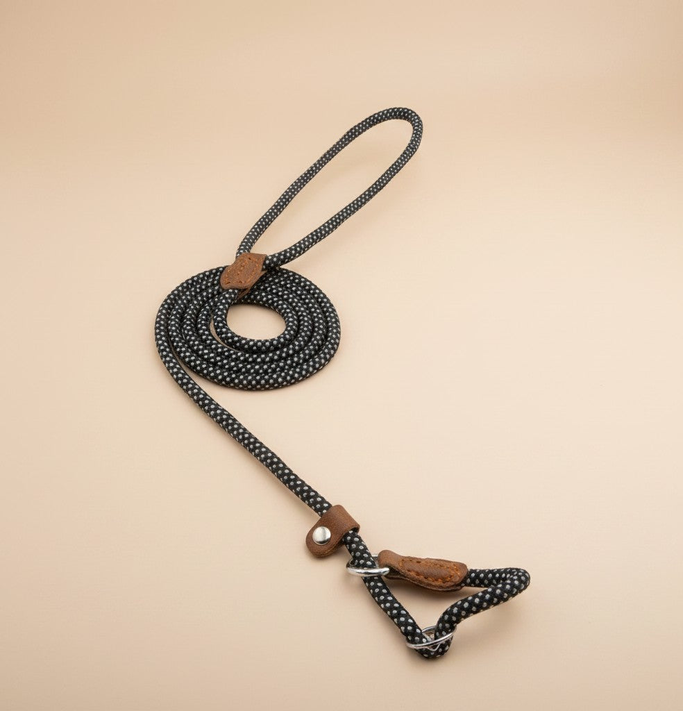 Nuzzle & Co black and white polka dot rope dog leash with brown leather accents on a neutral background